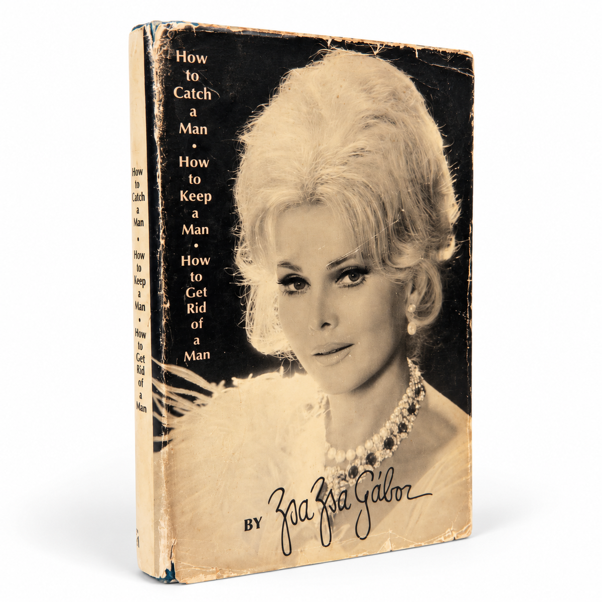 Vintage hardcover edition of How to Catch a Man, How to Keep a Man, How to Get Rid of a Man by Zsa Zsa Gabor, featuring the original black-and-white portrait dust jacket with visible vintage wear.