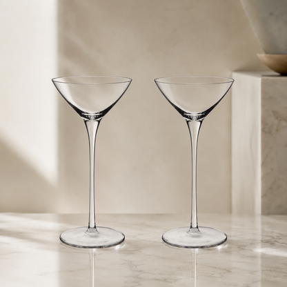 Two petite martini glasses on marble in elegant neutral dining room