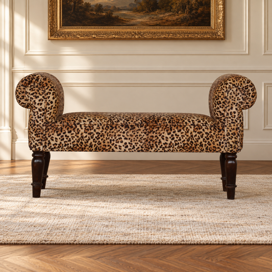 Front view of the leopard-print velvet bench with symmetrical rolled arms and walnut-finish turned legs.