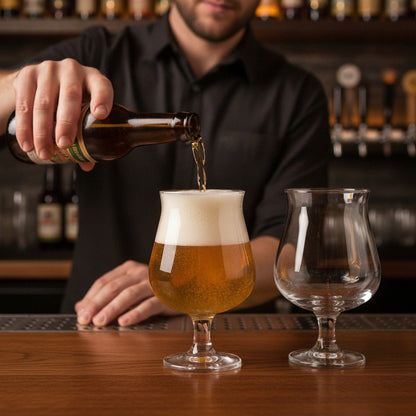Bartender pouring golden beer into professional Belgian beer glassware at a pub